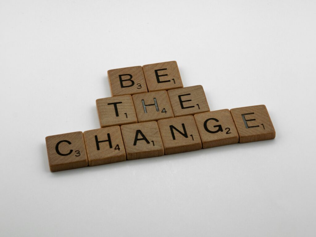 Scrabble tiles spell "Be the Change".
